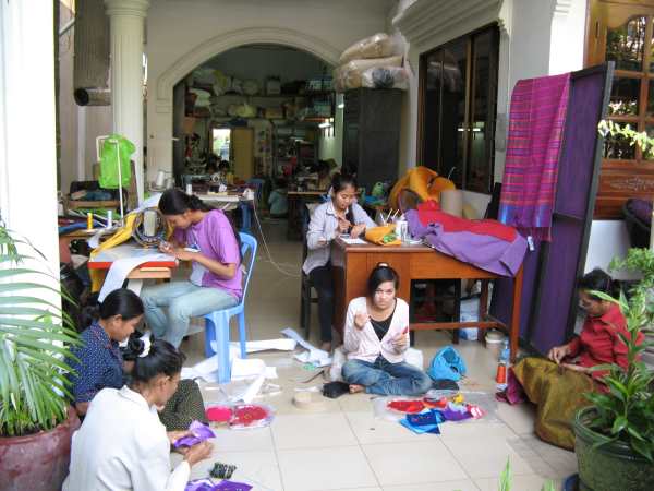 Young women sewing in work area attached to Le Rits hotel and restaurant